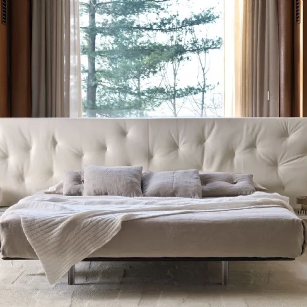 Bed with a wide quilted fabric headboard Chance Up by Desirèe