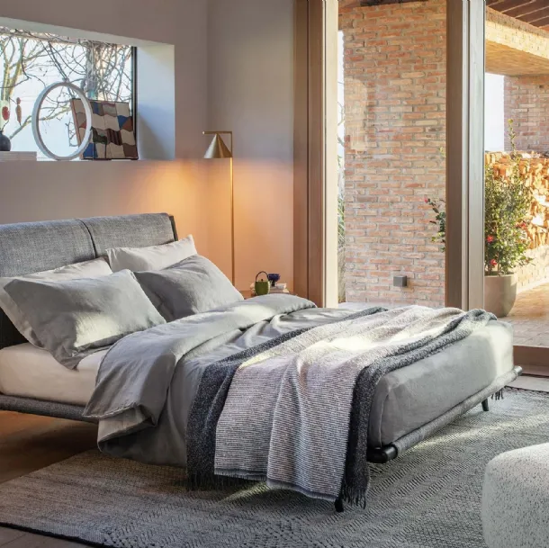 Fabric bed with Gaudì wooden frame by Flou