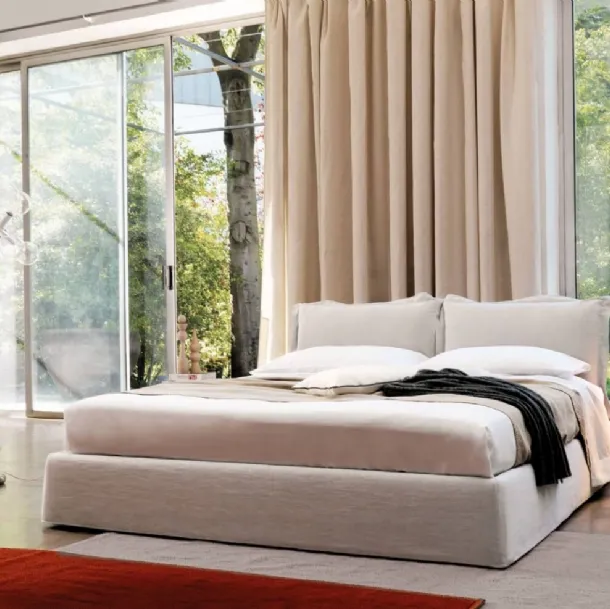 Bed with a headboard composed of two soft, padded fabric cushions from Desirèe's Vanity collection