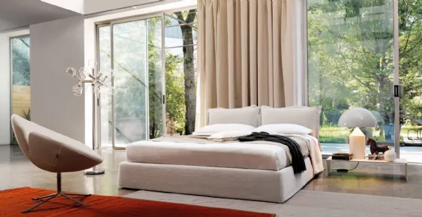 Bed with a headboard composed of two soft, padded fabric cushions from Desirèe's Vanity collection
