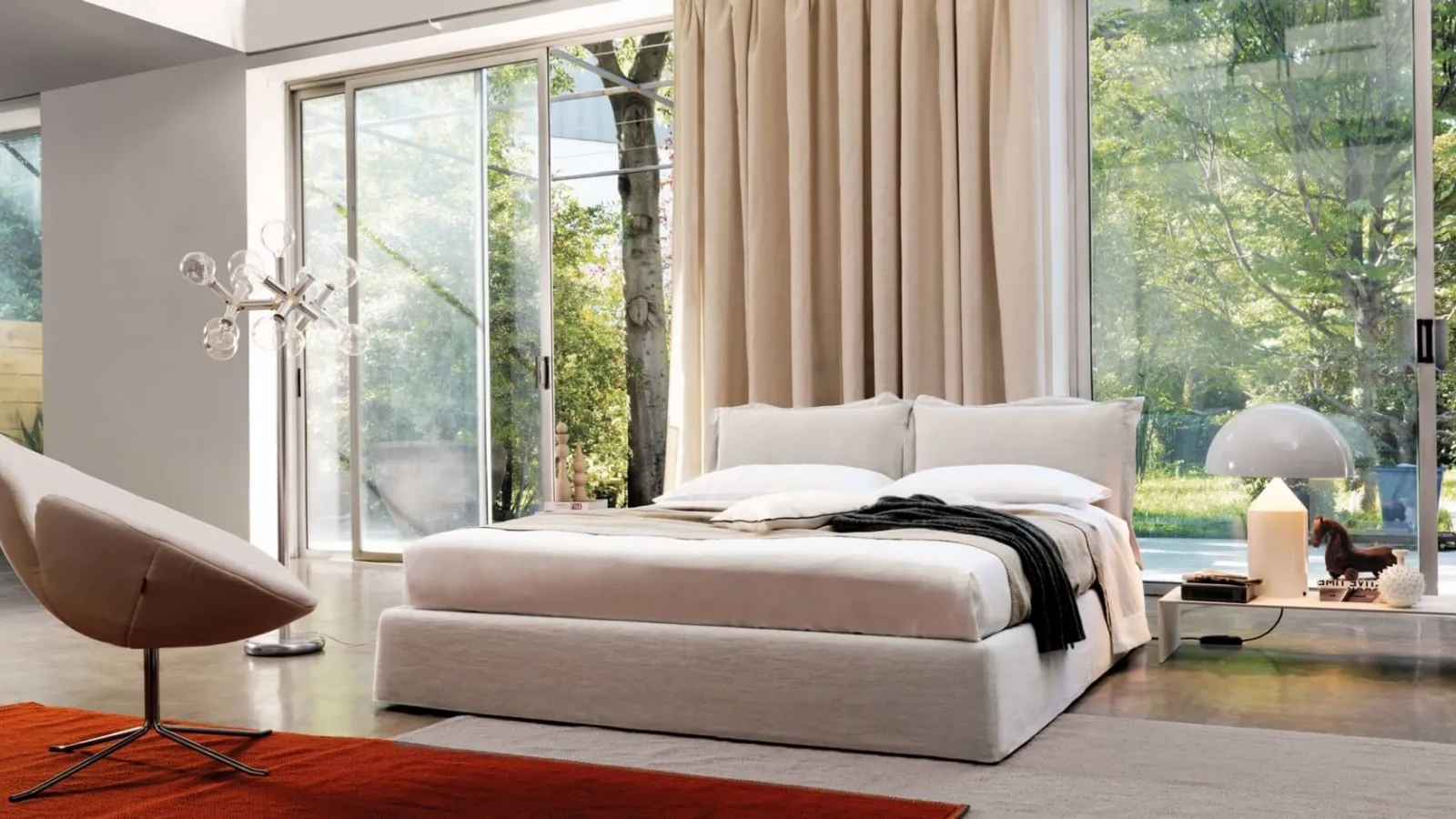 Bed with a headboard composed of two soft, padded fabric cushions from Desirèe's Vanity collection