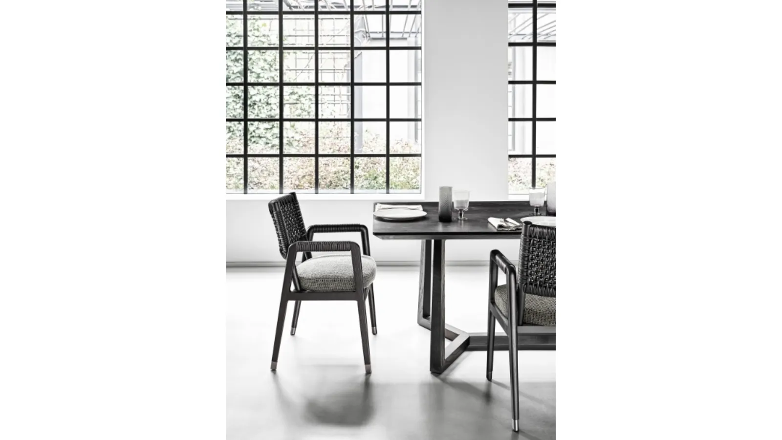 Ortigia Chair with solid wood frame, woven leather backrest, and upholstered fabric seat by Flexform