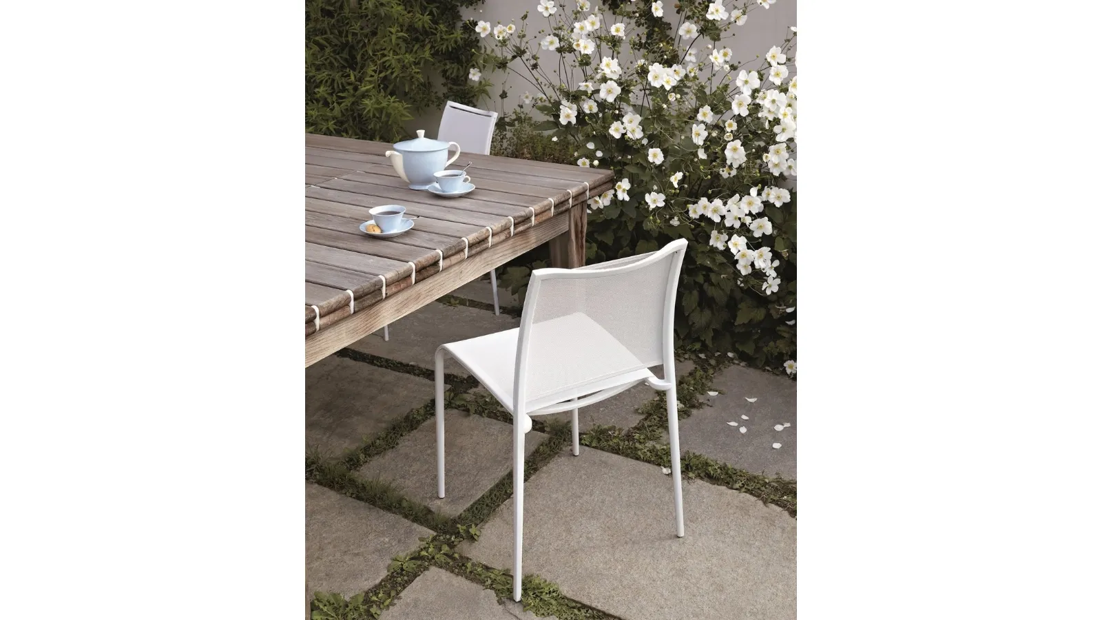 Stackable and lightweight Sand Light chair in polyester mesh and aluminum by Desalto
