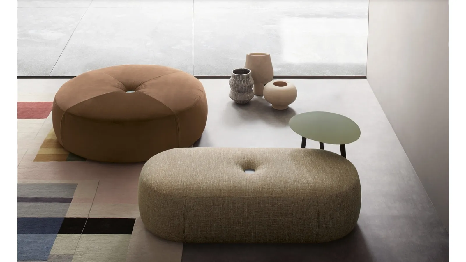 Round and oval pouf in padded Aley fabric by Lema