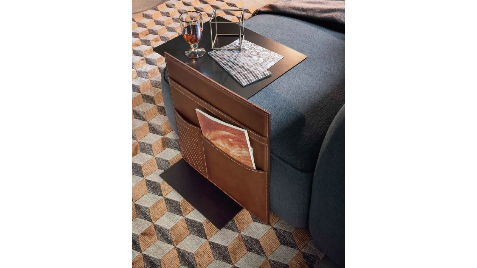 Metal side table with a leather magazine holder by Lema