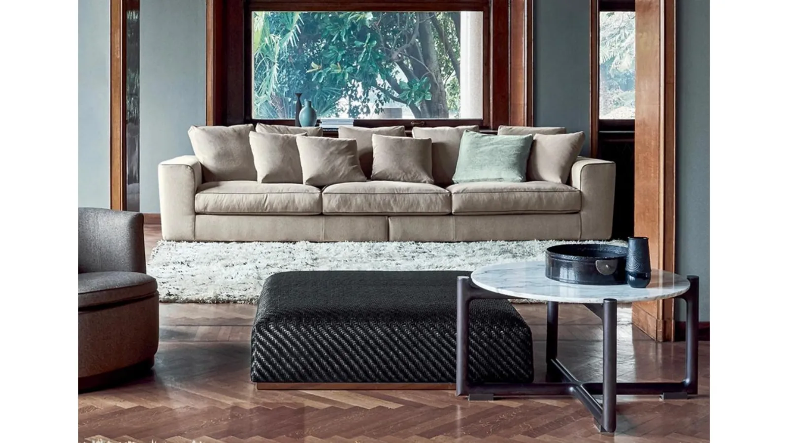 Carmen pouf in braided leather with metal base by Flexform
