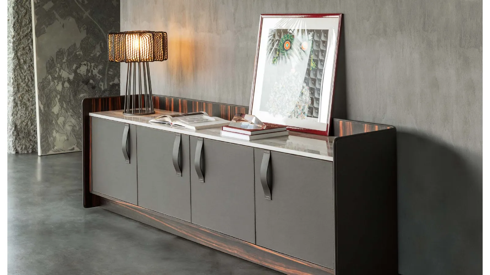Madia Gentleman with a curved plywood structure, externally covered in grey leather, internally in ebony with a Flou marble top