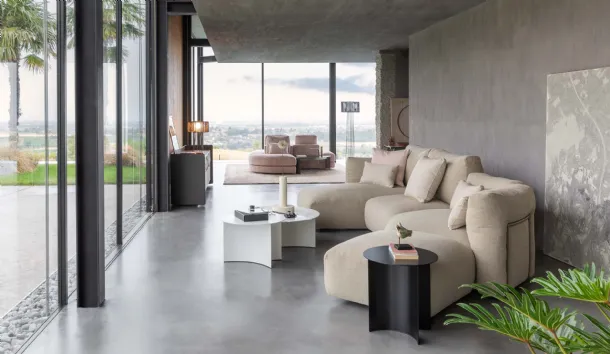 Upholstered fabric sofa with soft and curved lines and a Fiocco peninsula by Flou