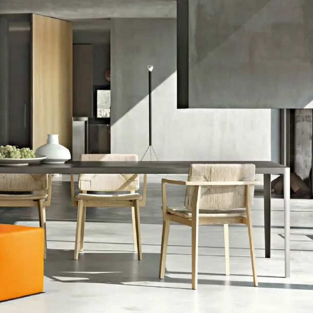Minimal rectangular table with concrete top and metal structure by Lema