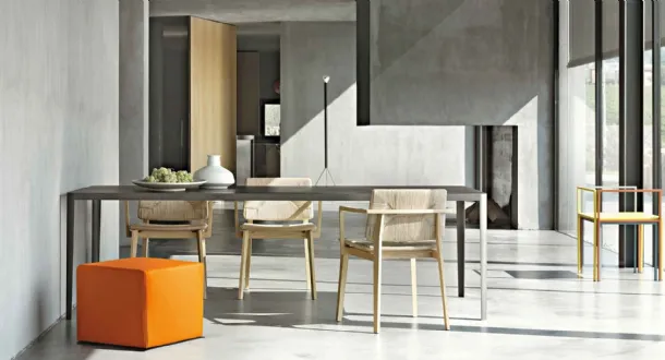 Minimal rectangular table with concrete top and metal structure by Lema