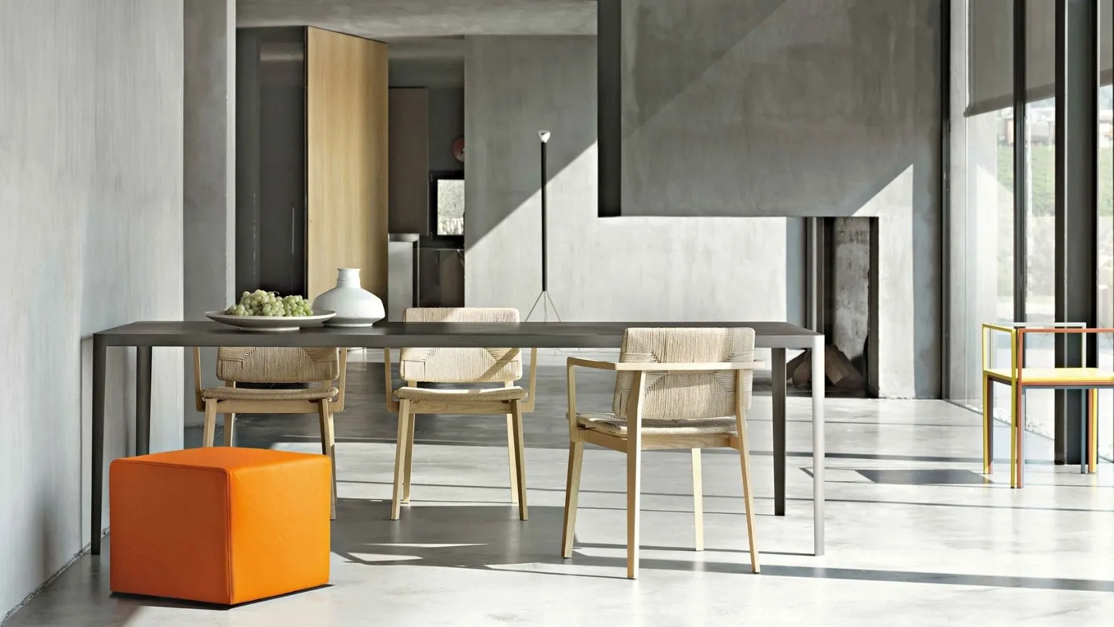 Minimal rectangular table with concrete top and metal structure by Lema