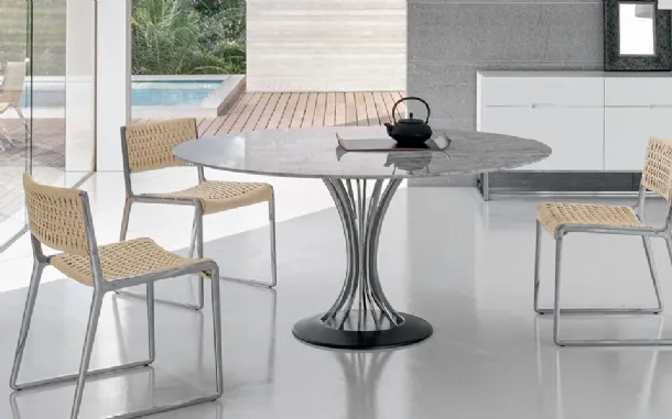 Round table with marble top, chrome steel legs, and cast iron base by Alivar
