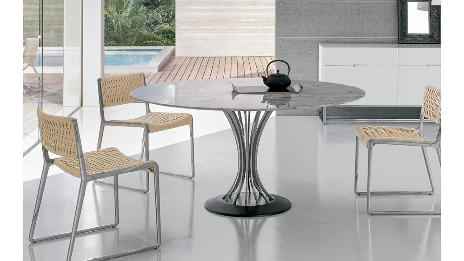 Round table with marble top, chrome steel legs, and cast iron base by Alivar