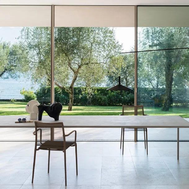 Elegant and compact 25 table with cement finish top by Desalto