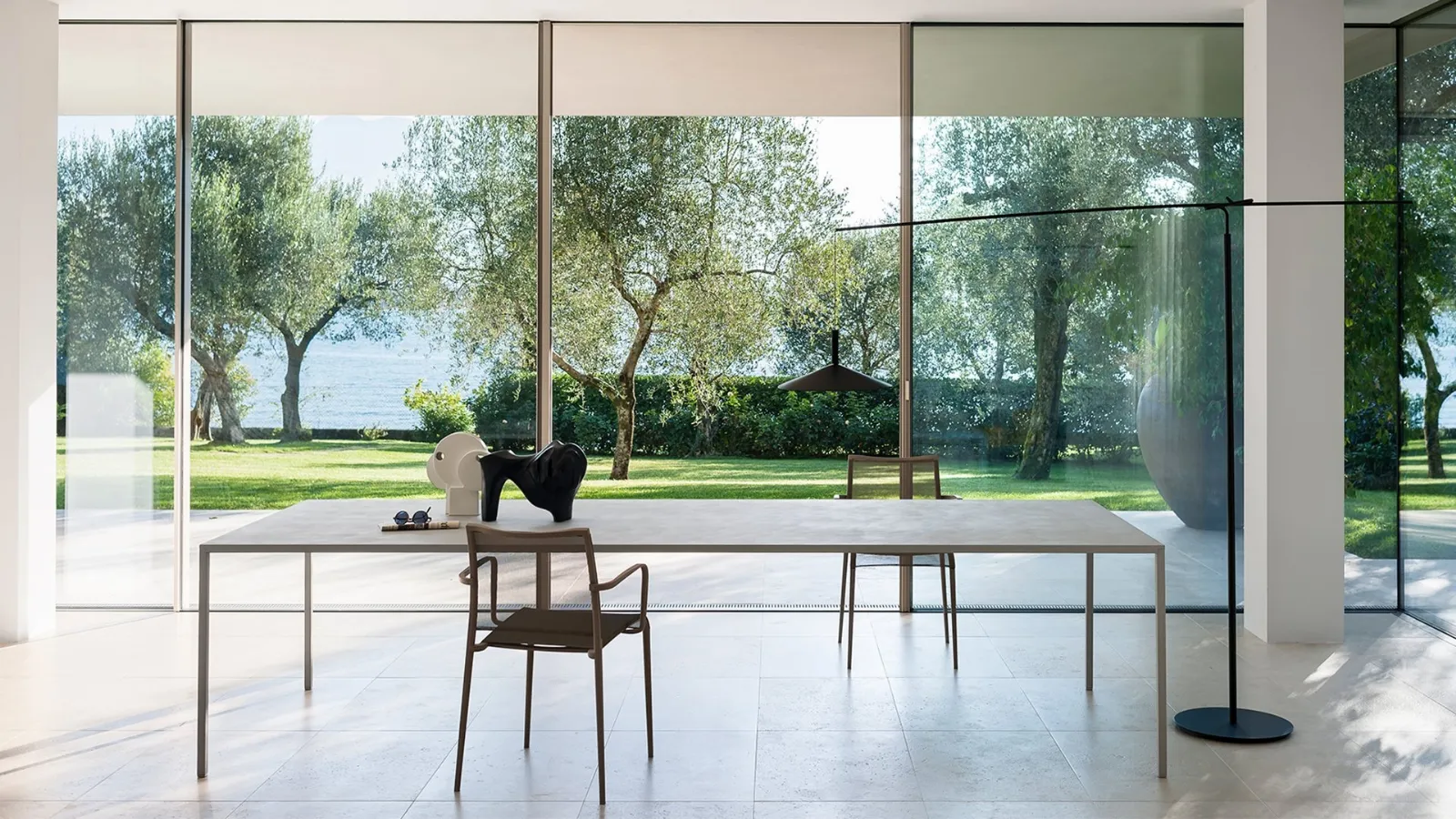 Elegant and compact 25 table with cement finish top by Desalto