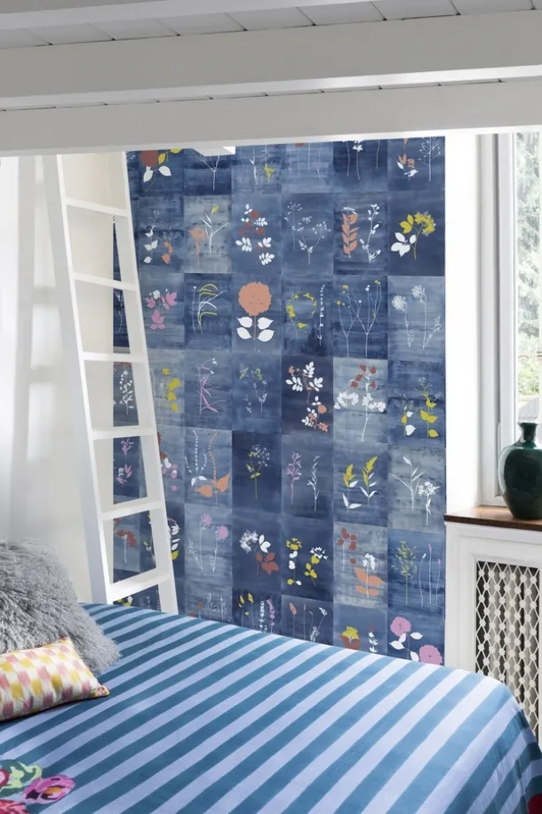 Wallpaper with decorated tiles on a Cyanopop blue background by Wall&Decò